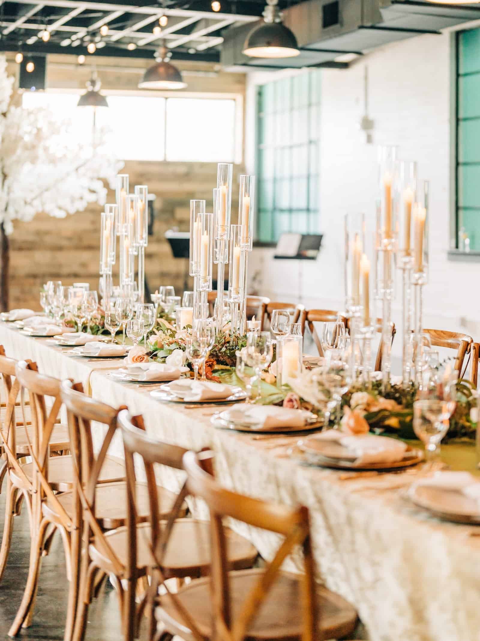 Ivory crushed velvet linen running the length of a banquet table with tall glass candelabra