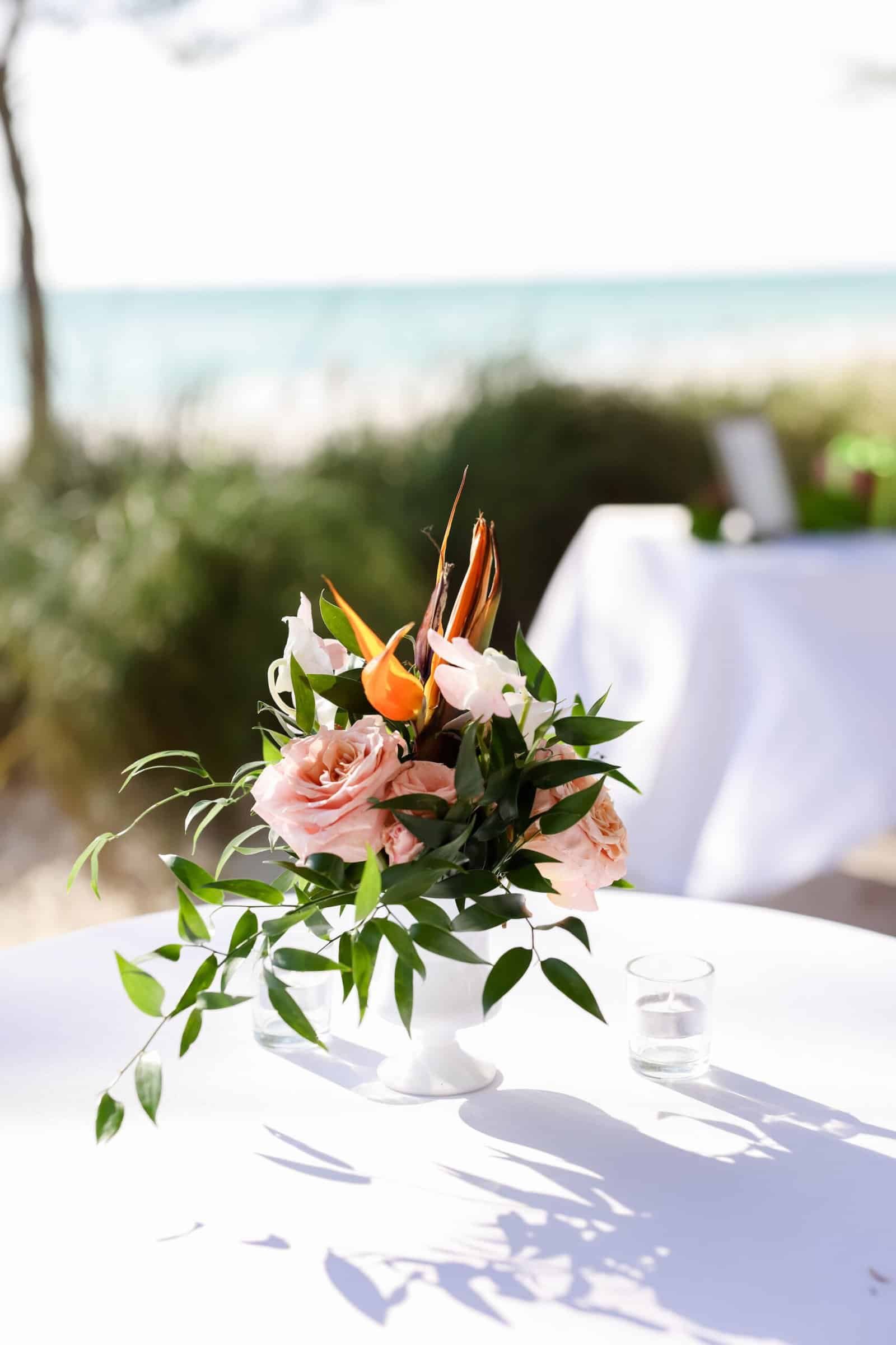 Round table dressed in white linen beside the dune at a Treasure Island beach wedding
