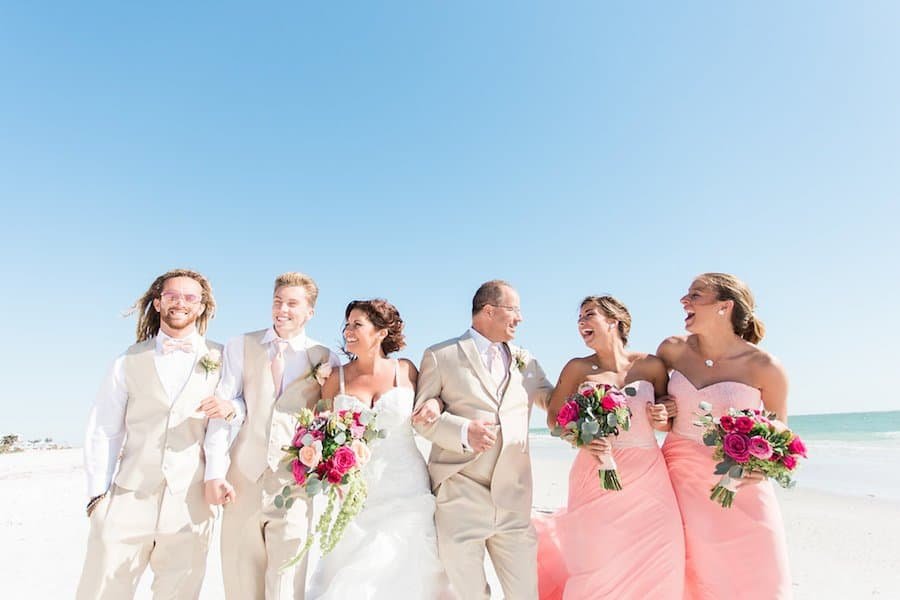 Wedding Party Posing with Sunglasses Along the White Sands of Siesta Key Beach