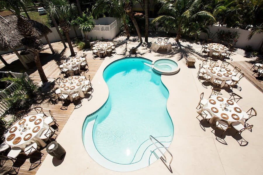 Woven Tabletop Chargers and Natural Wood Chairs by Gabro Event Services at Poolside Reception