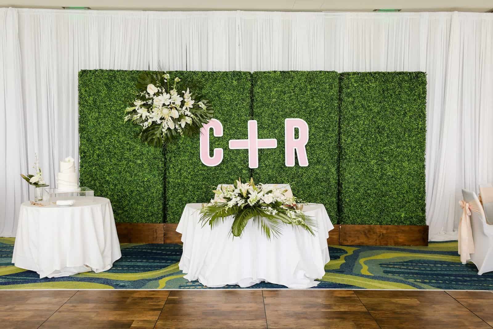Romantic Sweetheart Table with Greenery Wall, Custom Initials, and Woven Charger Settings by Gabro Event Services