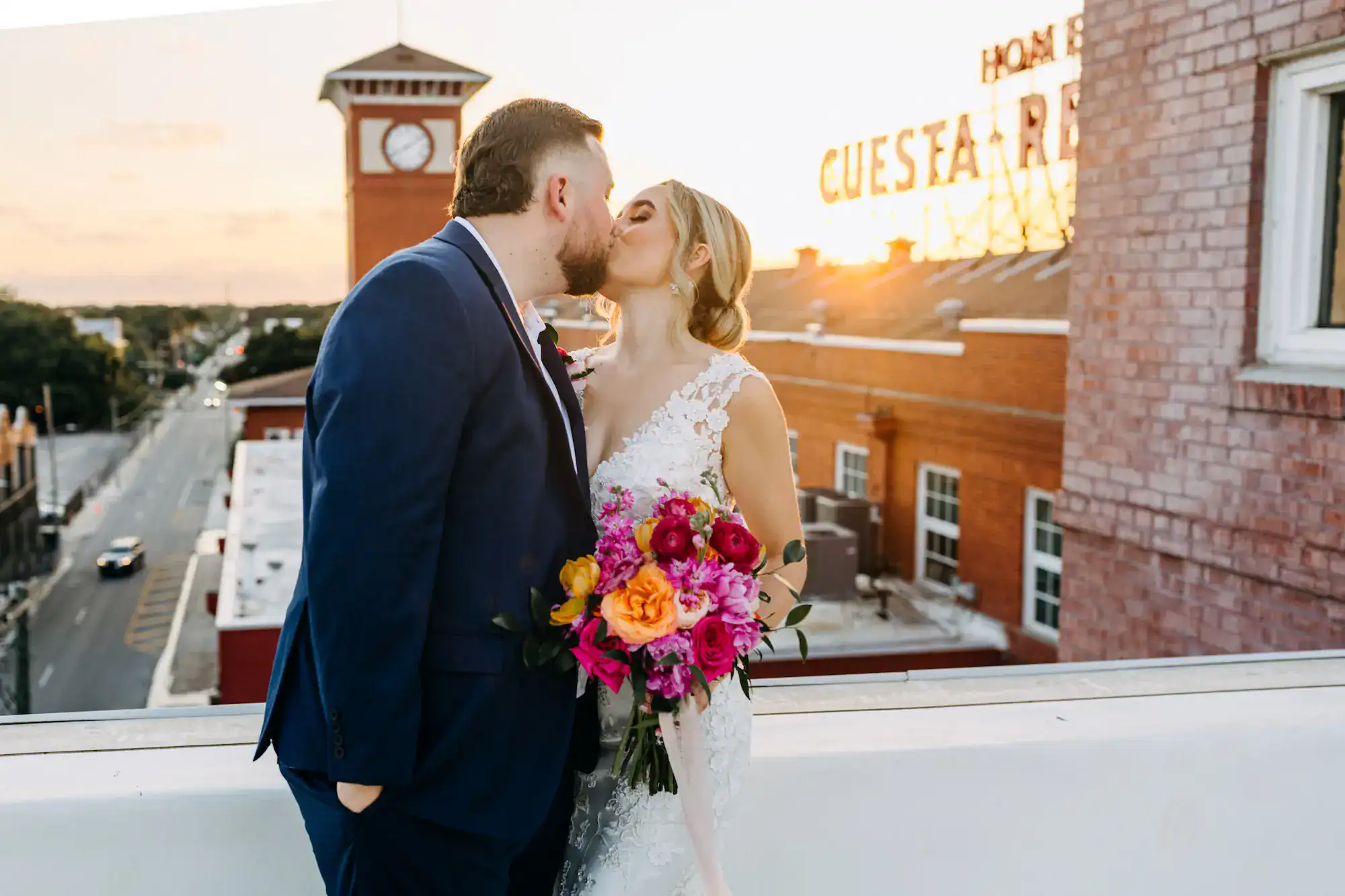 Vibrant pink and orange wedding reception decor with Gabro Event Services rentals at J.C. Newman Cigar Co