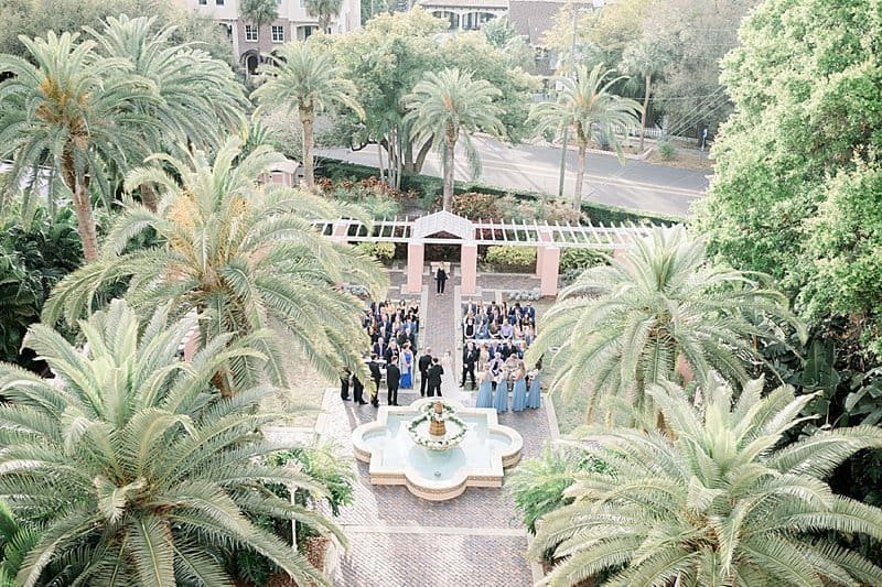 Dapper groom and groomsmen in black tie attire posing on the historic front steps of The Vinoy Renaissance