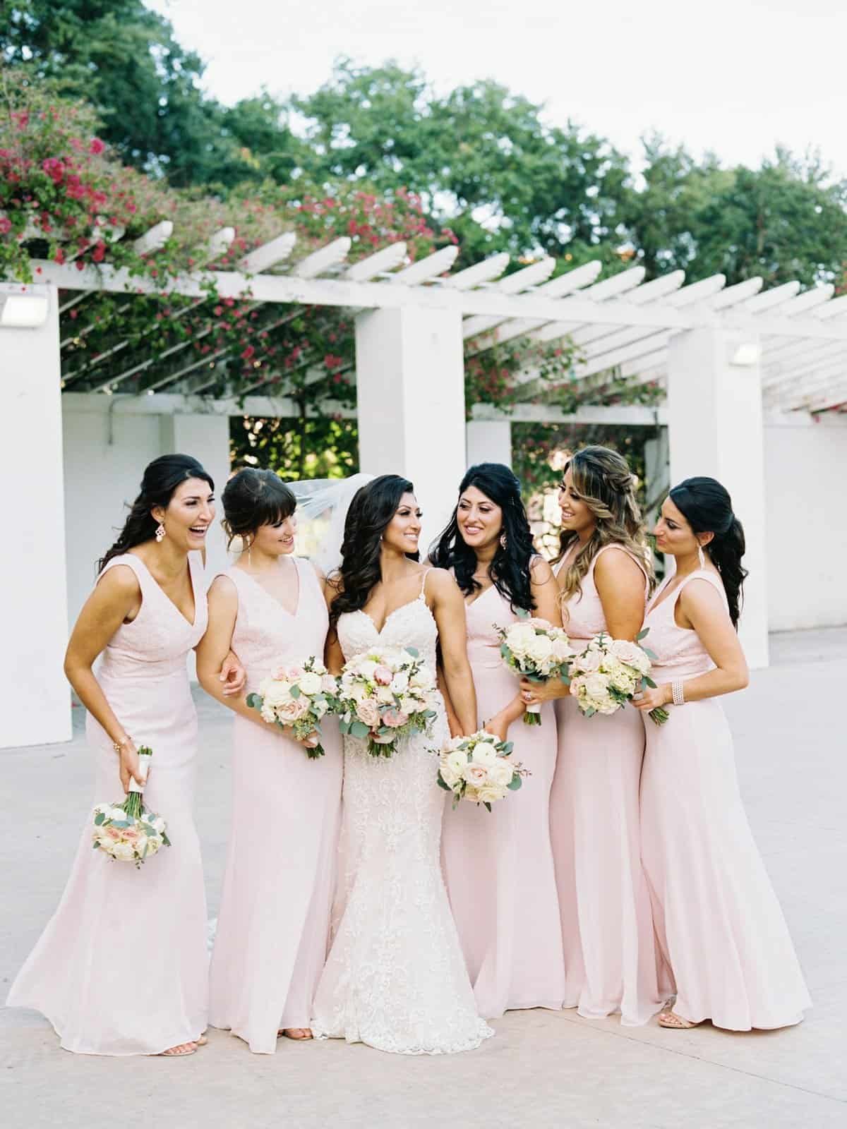 Nora with her bridesmaids in blush pink gowns along the waterfront at Vinoy Park in downtown St. Petersburg