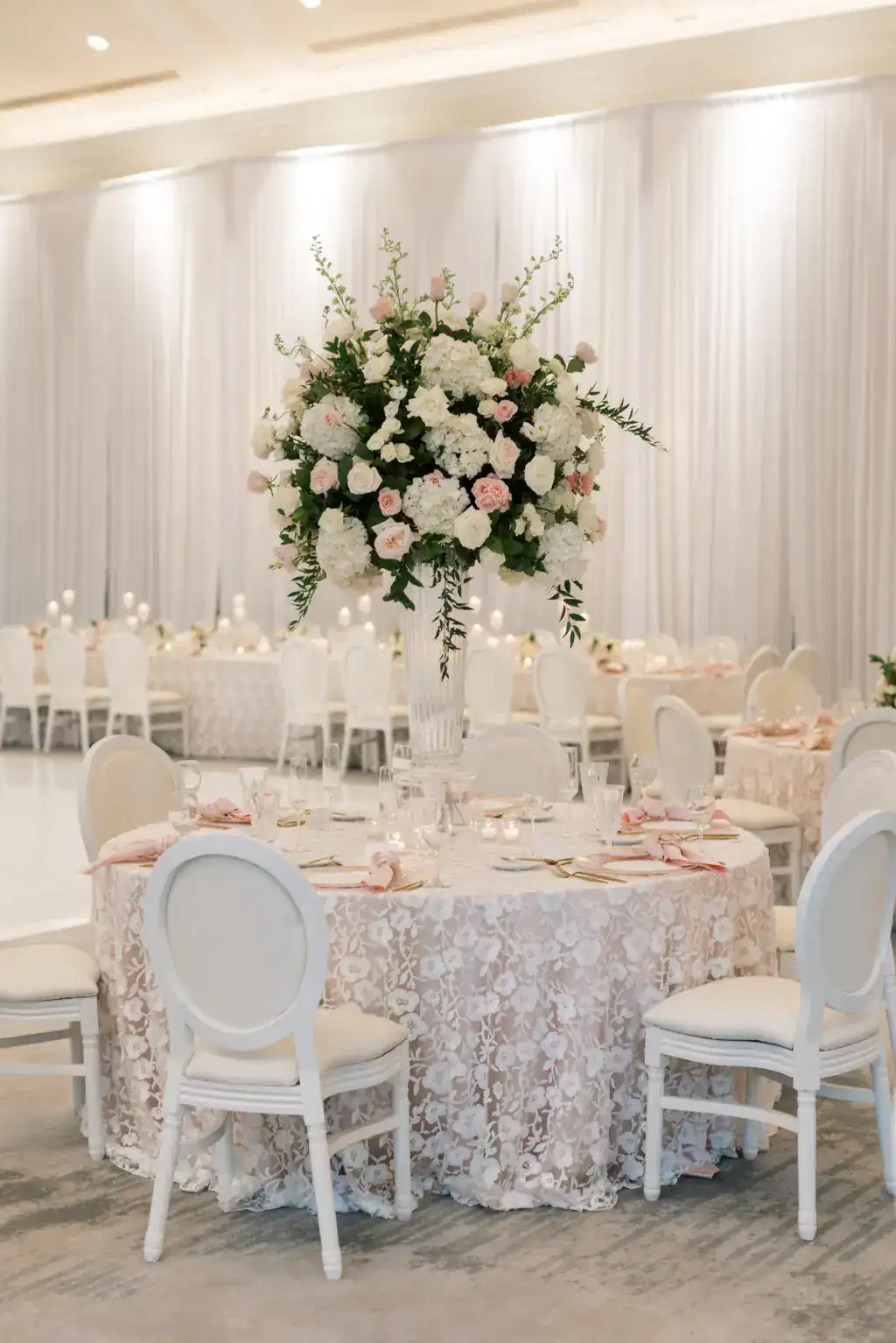 Tall centerpiece vase with white hydrangeas and pink roses by Bruce Wayne Florals