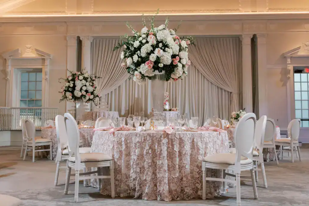 Ballroom dining tablescapes framed by Gabro Event Services custom ceiling and wall drapery