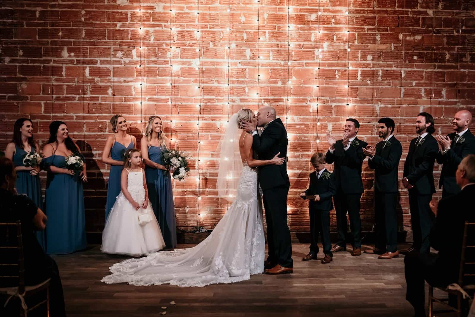 Luxurious red and gold wedding reception at The Vinoy Renaissance featuring custom ceiling fabric draping by Gabro Event Services and lavish red rose centerpieces
