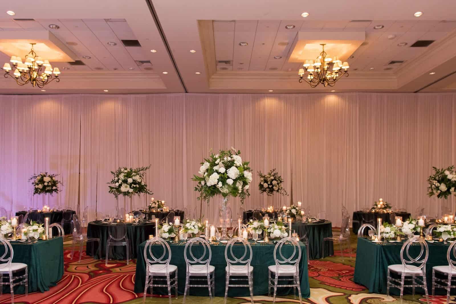 Vinoy Grand Ballroom Reception with Emerald Green Linens, Acrylic Chiavari Chairs, and Tall White Florals