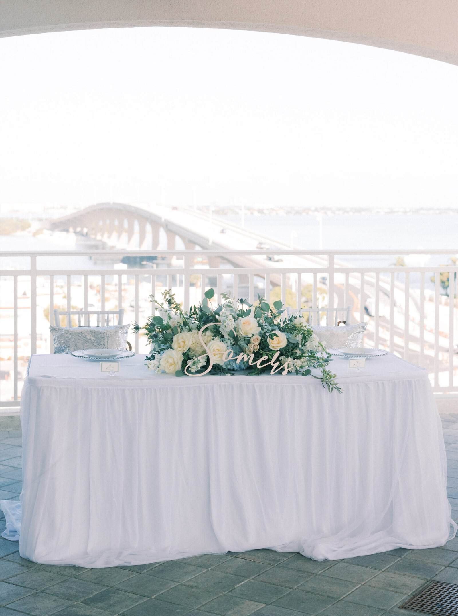 Elegant white reception chairs at Vista the Top decorated with blue cheesecloth fabric.