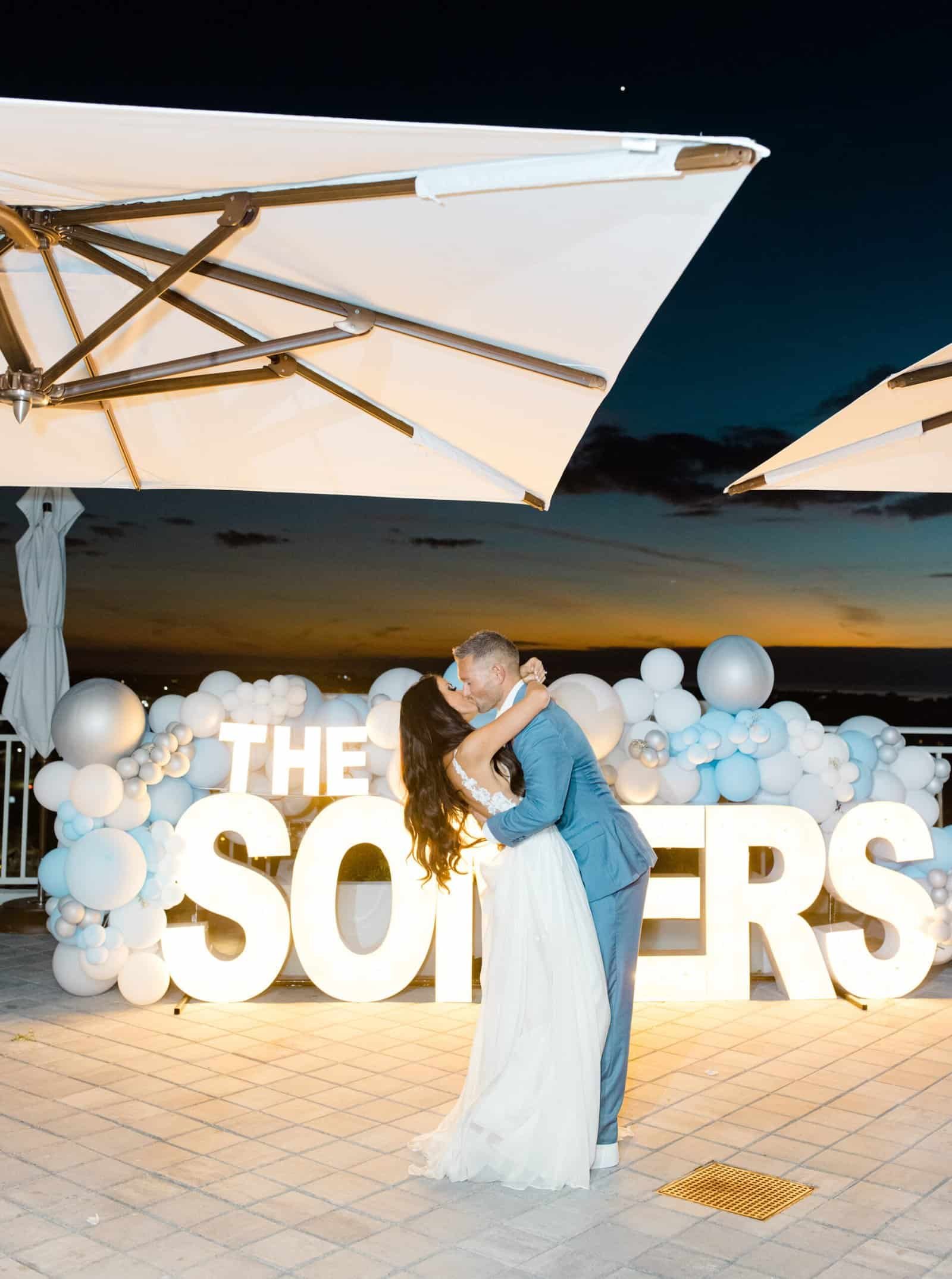 The bride and groom dancing on a rooftop at sunset in St. Pete.