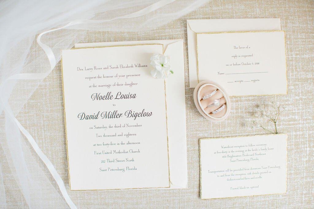 Outdoor waterfront wedding ceremony setup on a private estate lawn with floral-lined aisle in St. Petersburg