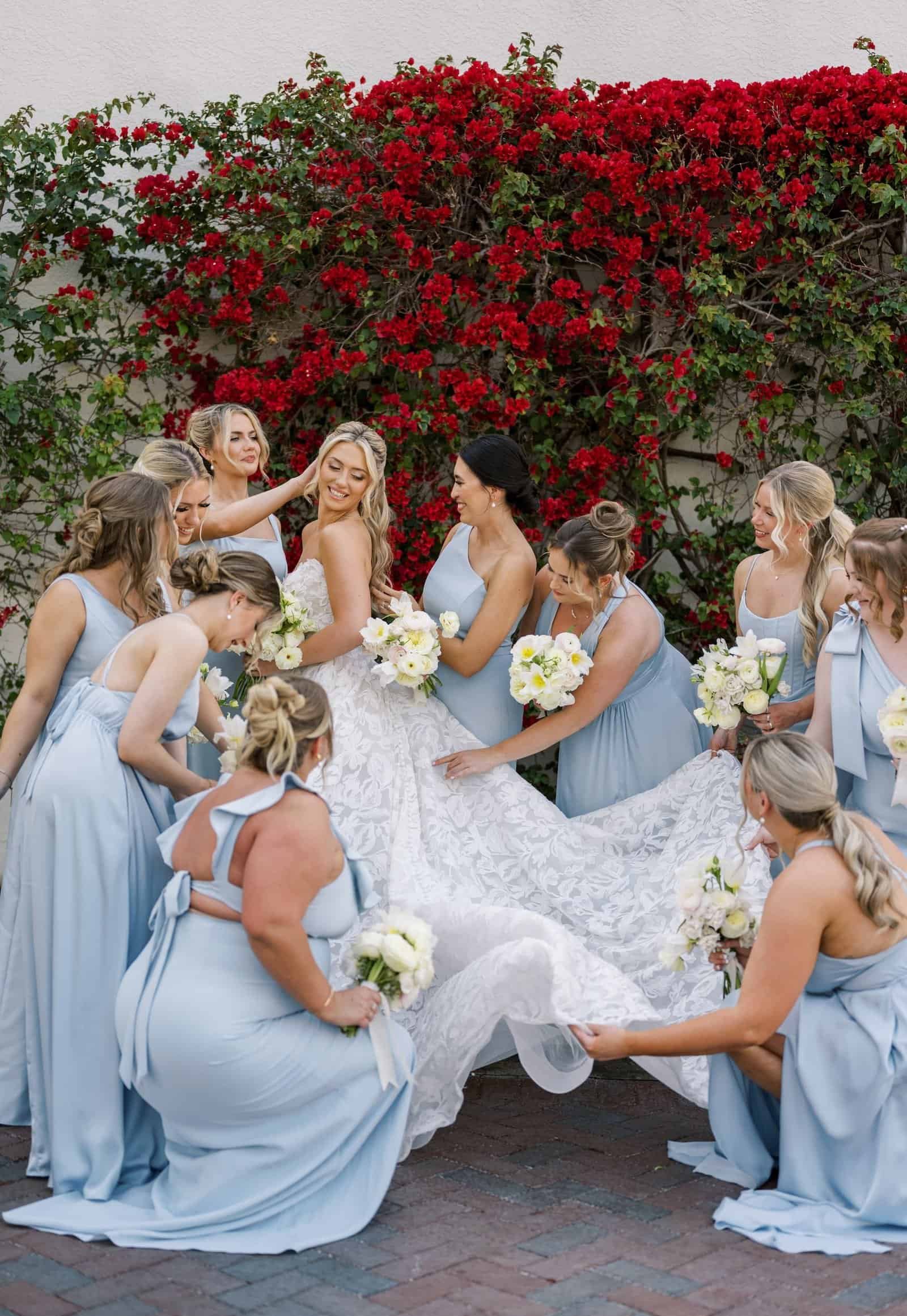 A beautiful waterfront wedding ceremony setup featuring white umbrellas and light blue floral arrangements.