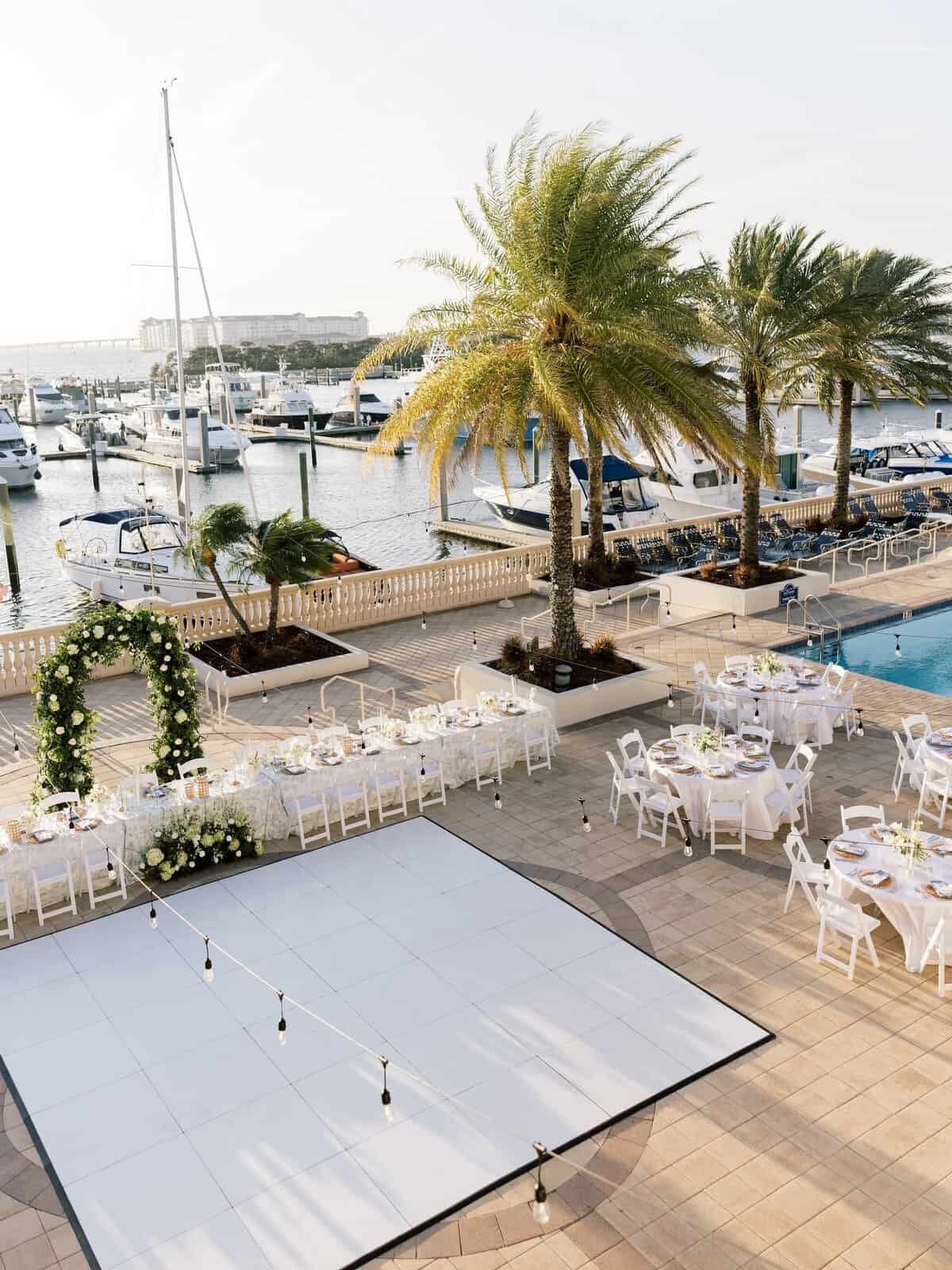 Harborside reception and dance floor beside the private yacht docks at dusk