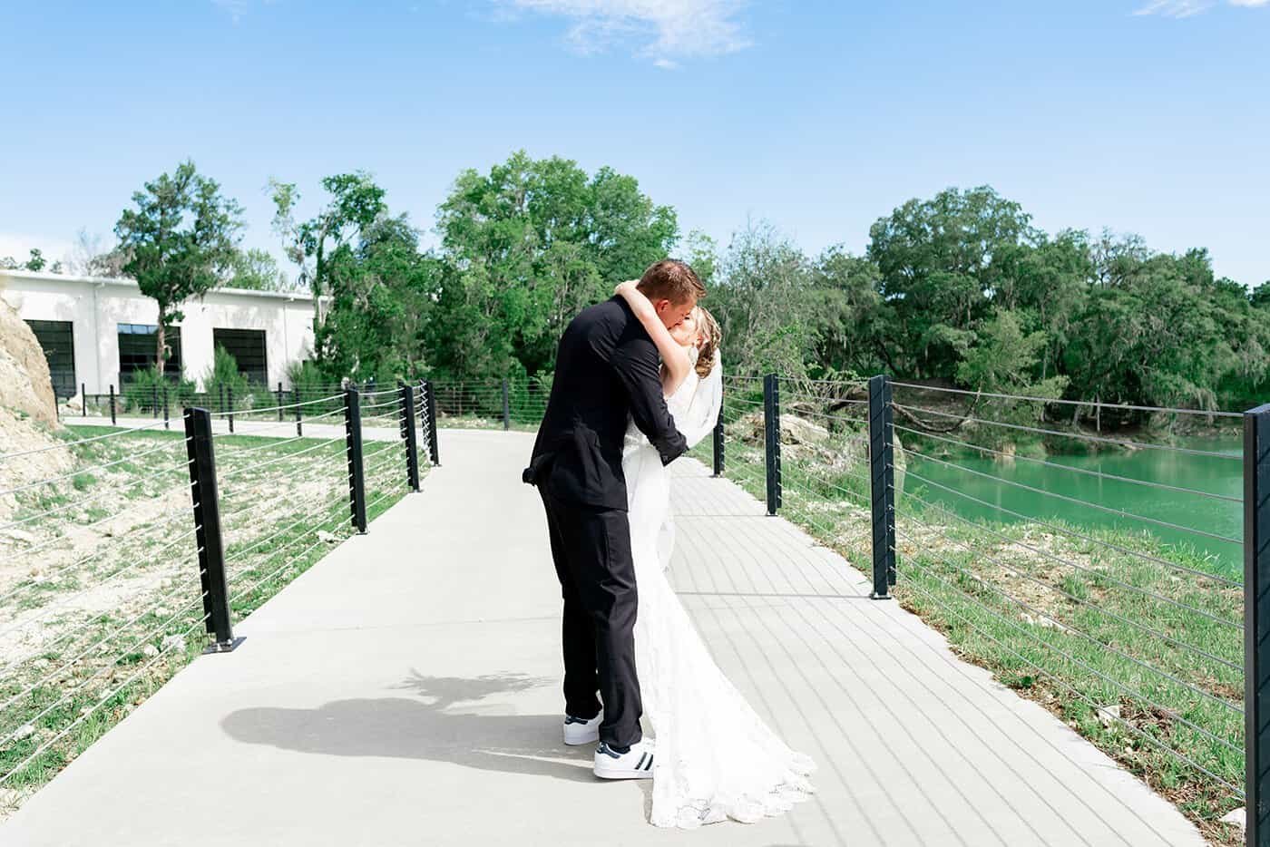 Couple exchanging heartfelt micro wedding vows beneath a Gabro Event Services wooden ceremony arbor