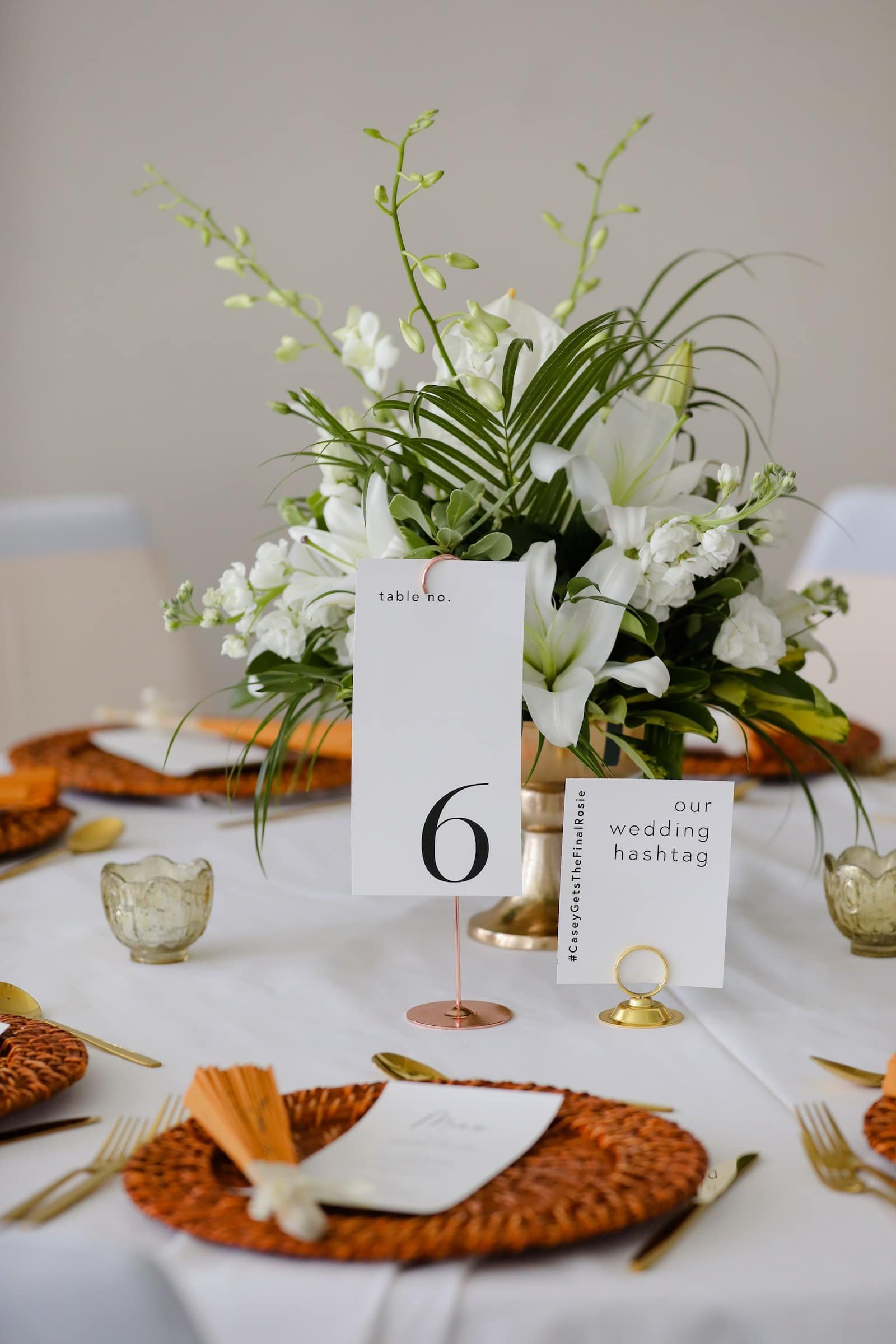 Detailed Table Setting with Natural Woven Charger Plate, Gold Flatware, and Custom Monogram Menu